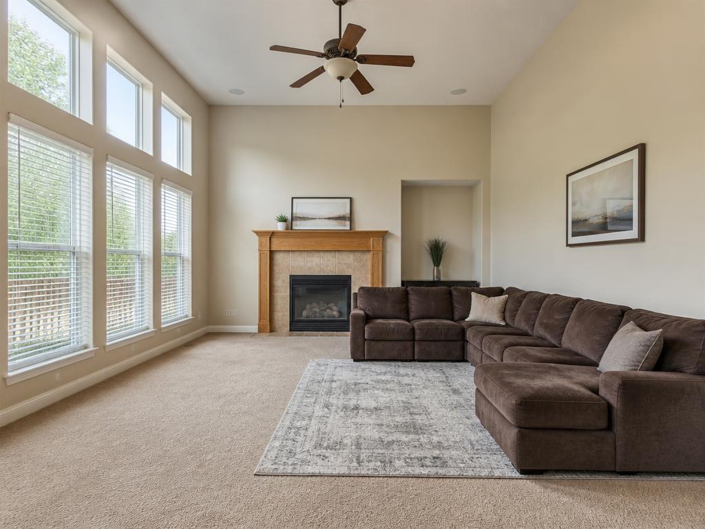 Large living room with beige walls and bulky furniture against the walls