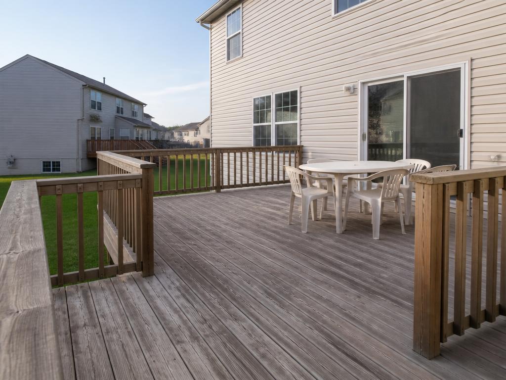 Weathered backyard deck with basic plastic furniture
